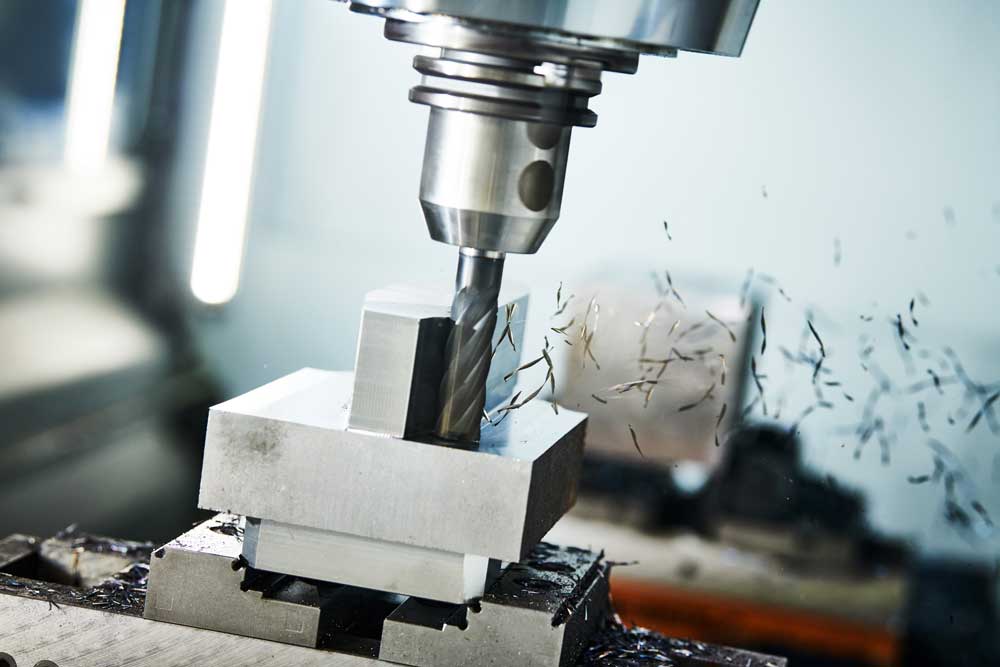 milling cnc machine at metal work industry. Multitool precision machining. Shallow depth of view on shavings